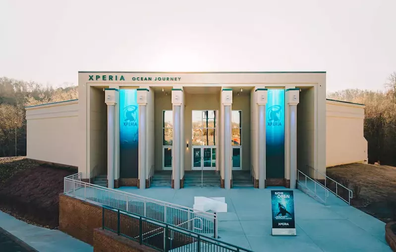 The outside of the Xperia Ocean Journey building with large columns.